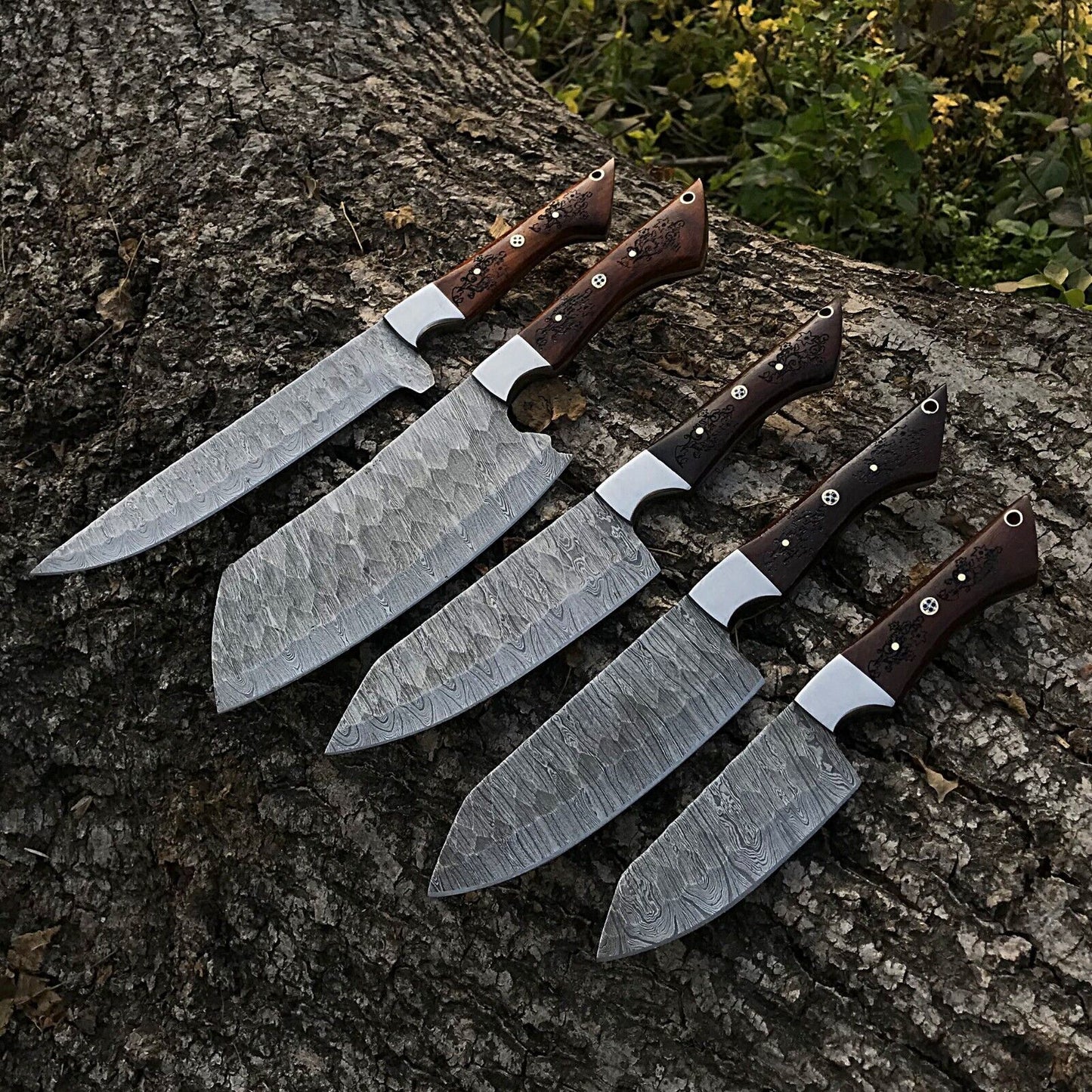 5pc custom handmade Damascus chef knife set featuring forged steel blades and ergonomic handles arranged for display.