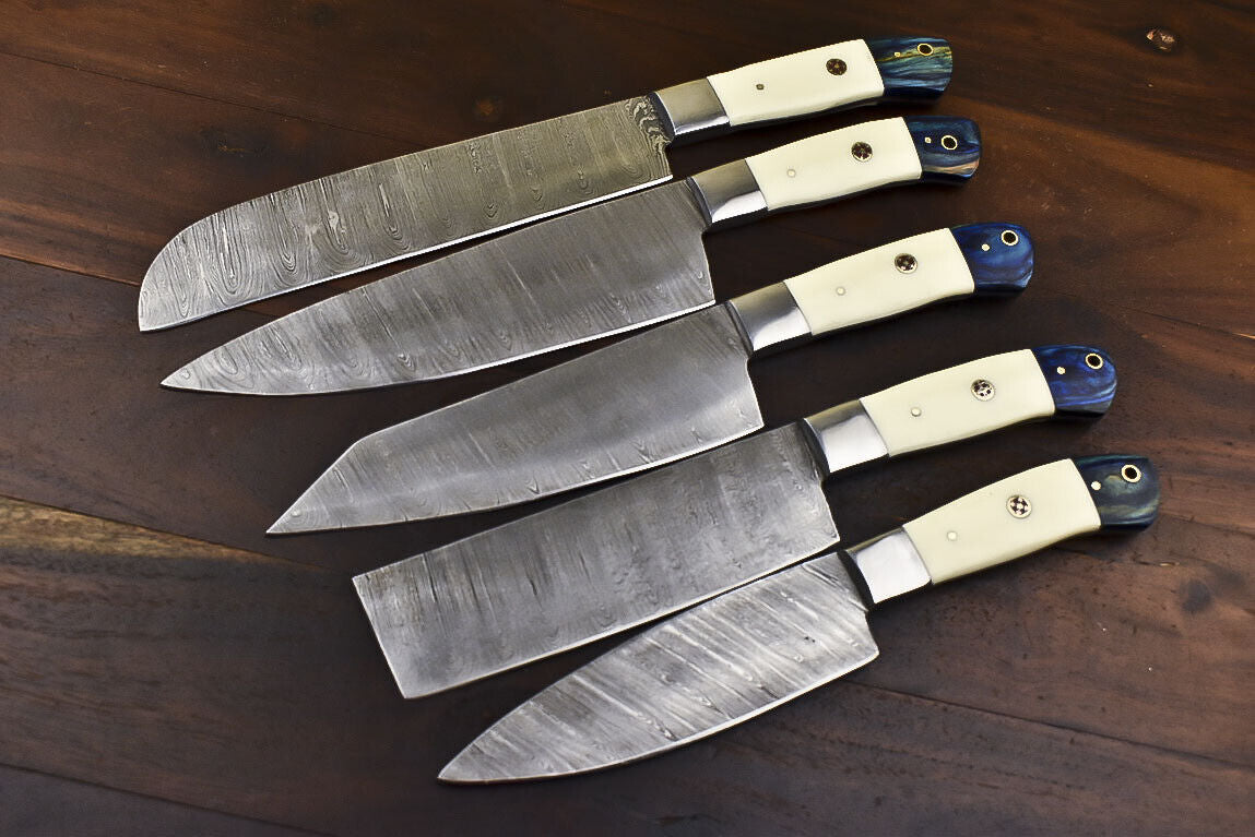 Complete 5 pc Damascus steel chef knife set arranged with their hand tooled leather sheaths.