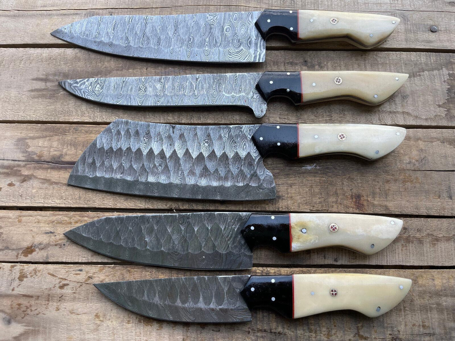 Close up of hand forged Damascus steel pattern on a custom chef kitchen knife with satin polish.