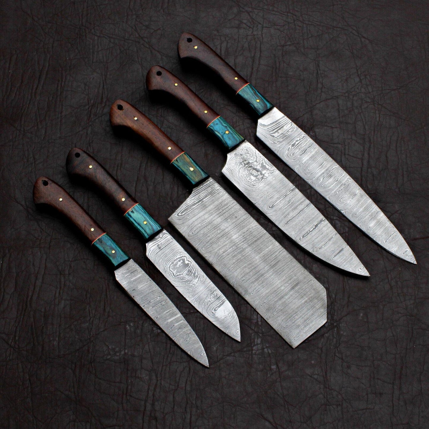 5pc custom handmade Damascus chef knife set with forged steel blades on a rustic wooden background.