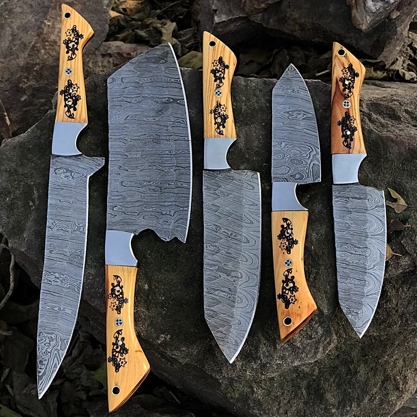 5pc custom handmade Damascus chef knife set featuring forged steel blades and unique ergonomic handles on a rustic wood background.