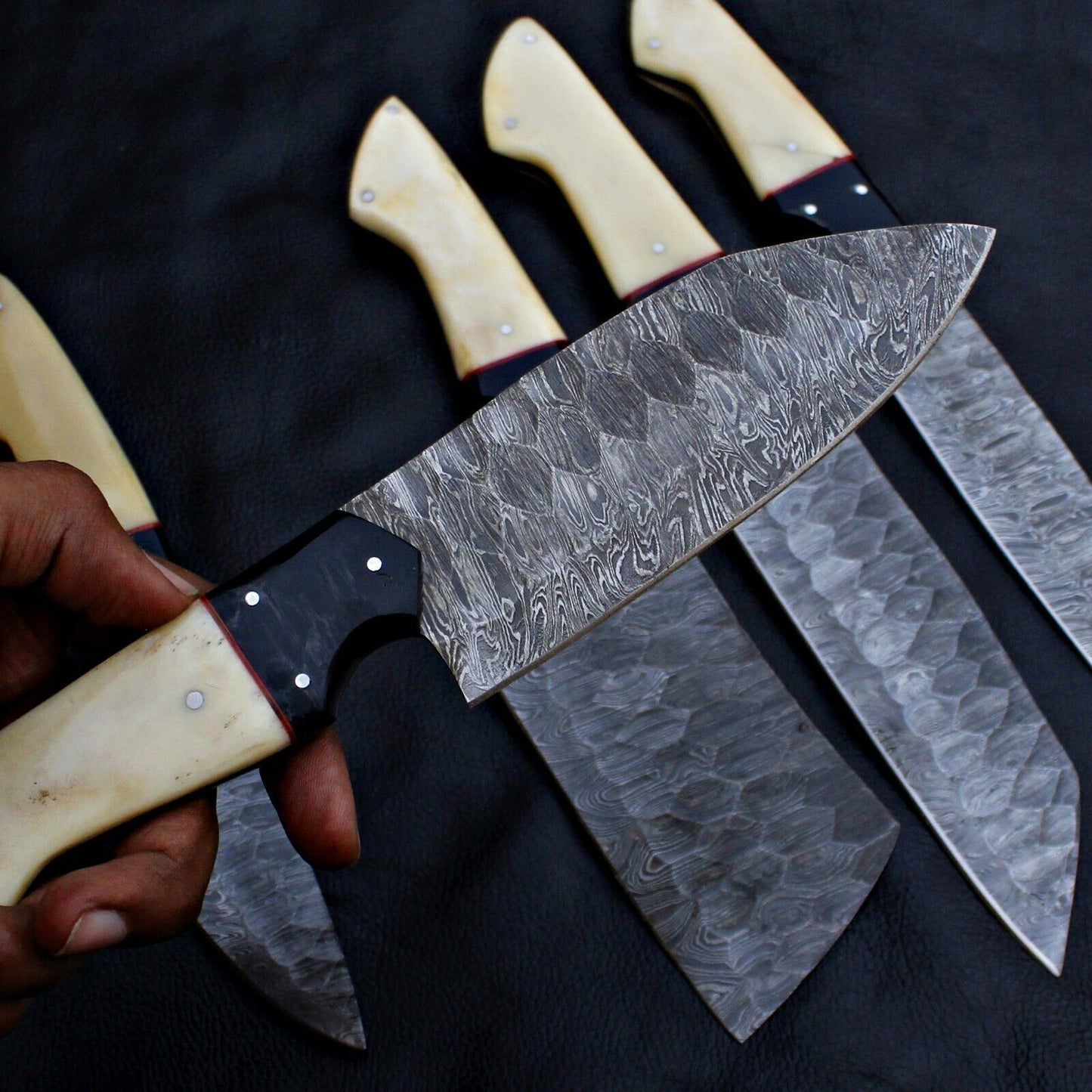 Detailed view of unique, hand forged Damascus steel blade pattern on a custom kitchen chef knife.