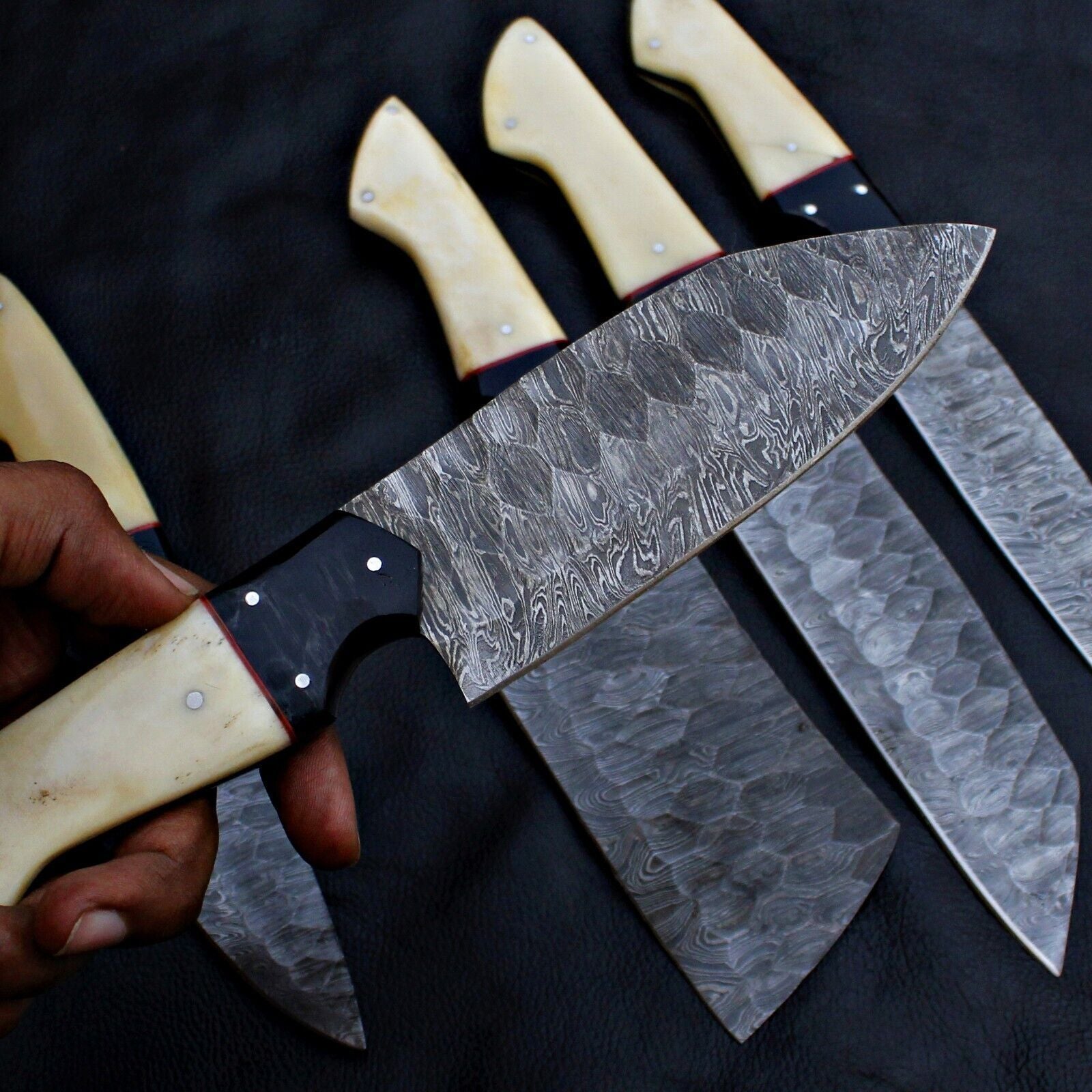 Detailed view of unique, hand forged Damascus steel blade pattern on a custom kitchen chef knife.