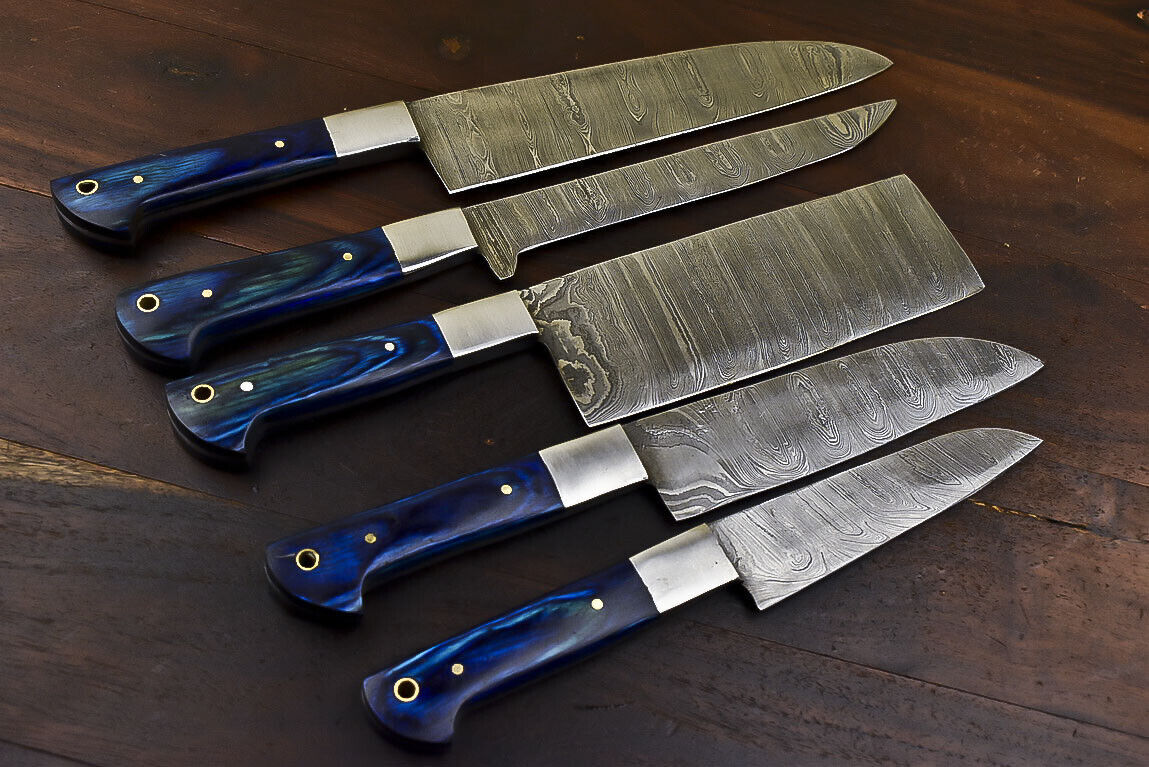 Premium 5 piece Damascus kitchen knife set featuring hardwood handles and steel bolsters displayed on rustic timber.