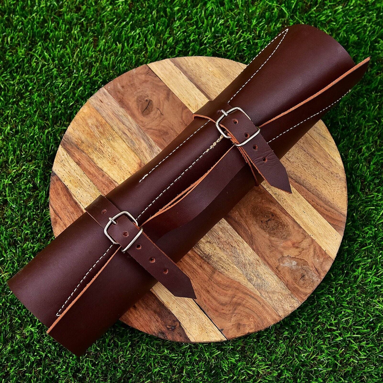 Hand stitched leather roll kit containing a 5 pc custom Damascus steel chef knife set for professional storage and travel.