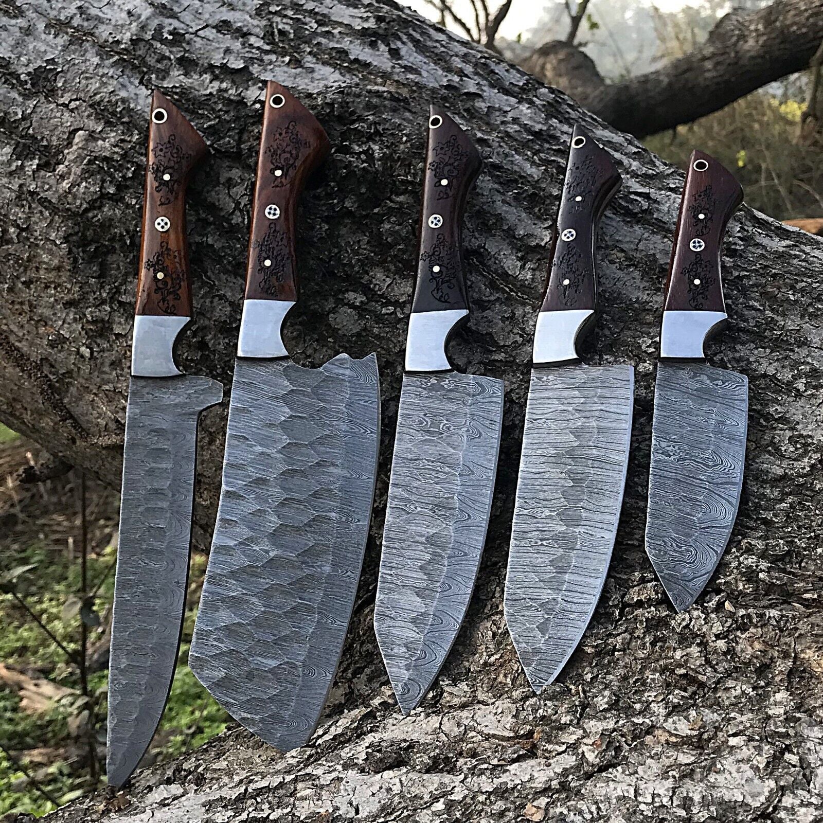 5pc custom handmade Damascus chef knife set featuring forged steel blades and ergonomic handles arranged for display.