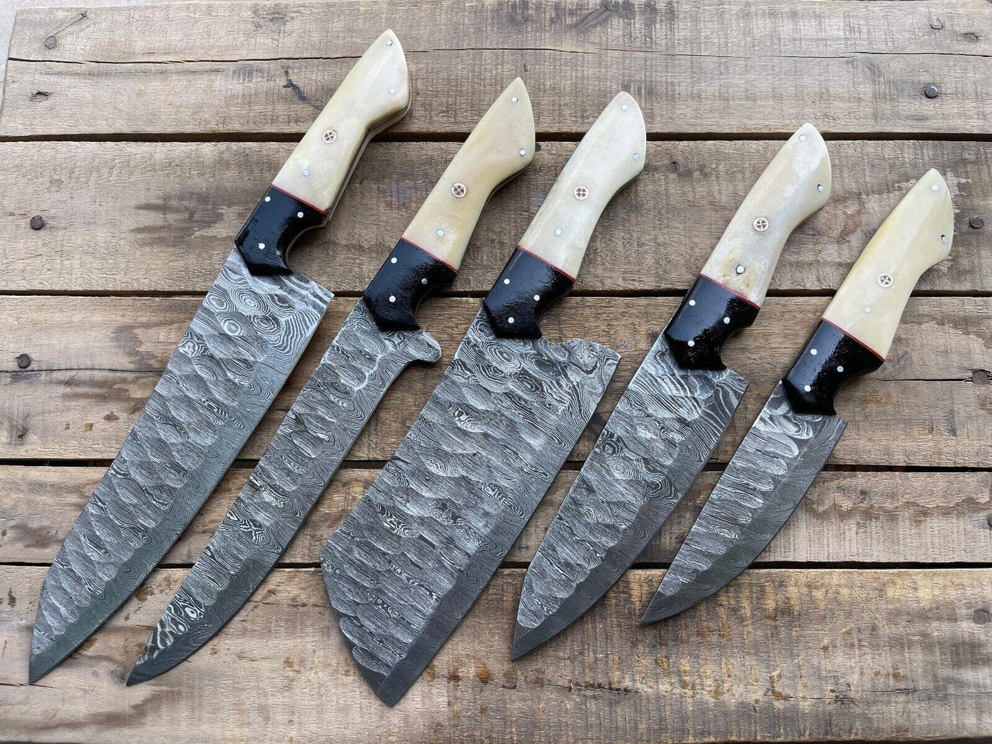 5 pieces custom handmade Damascus chef knife set displayed on a wooden surface, featuring premium Damascus steel blades and ergonomic handles