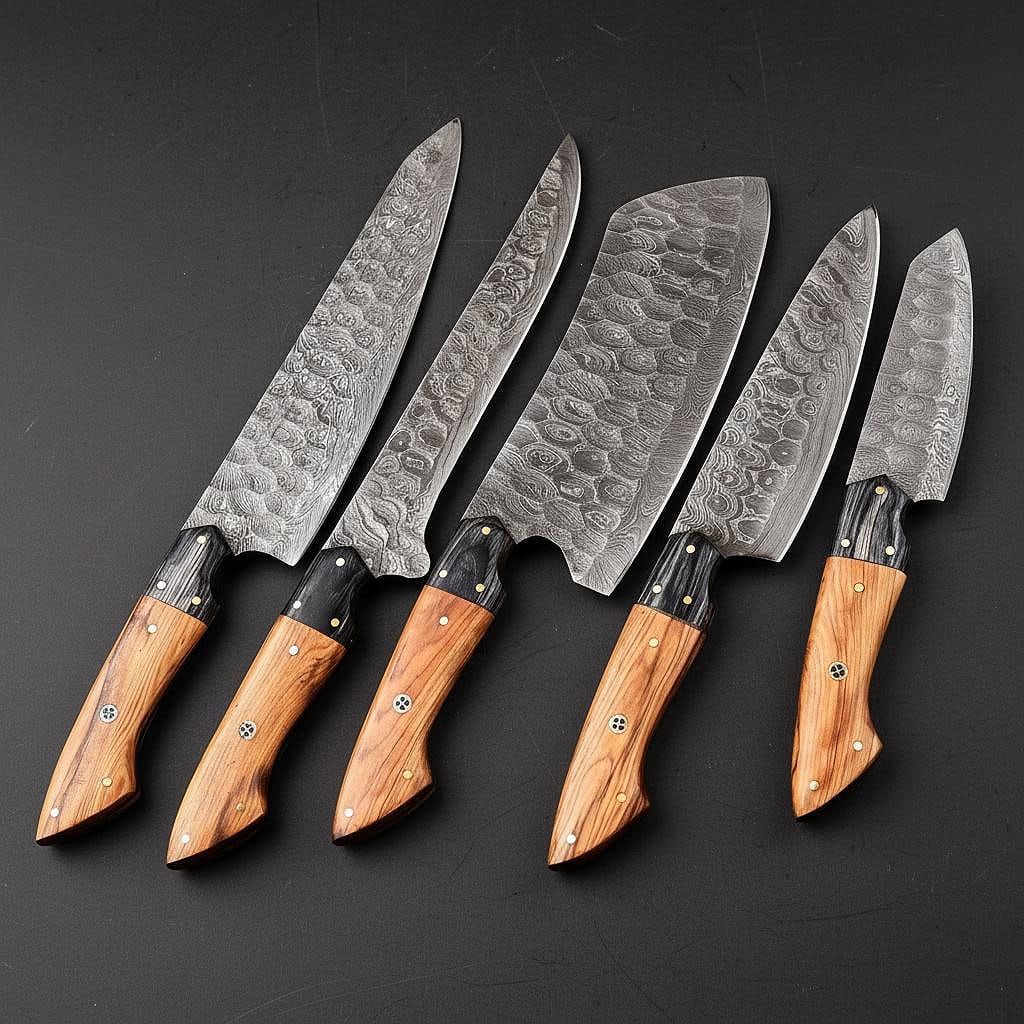 Hand forged 5 piece Damascus steel kitchen knife set with leather storage sheath, displayed on rustic wood.